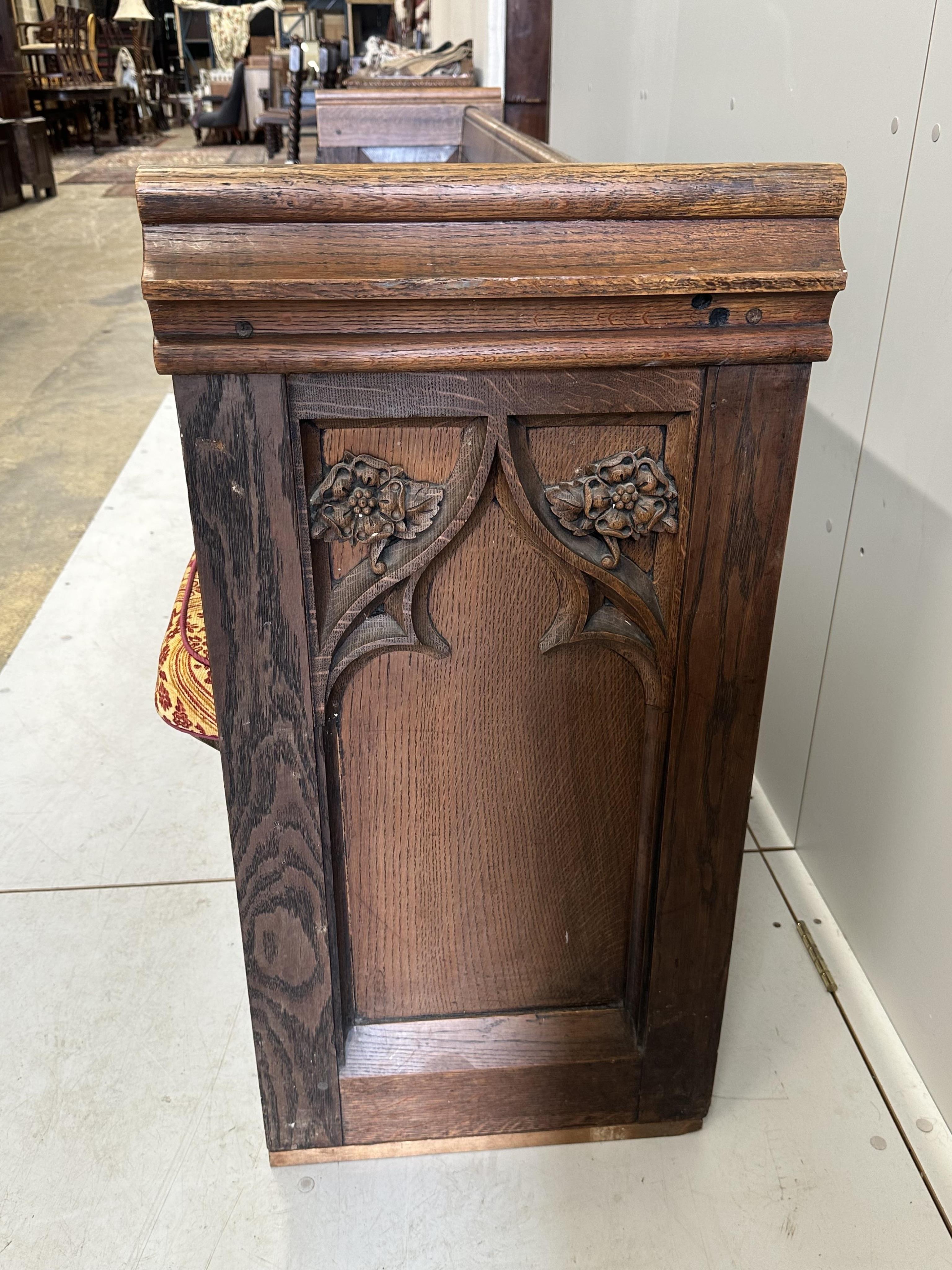 A Victorian Gothic style carved oak pew, width 228cm, depth 48cm, height 89cm. Condition - good